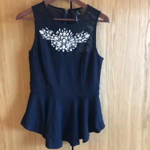 Partytopp från Forever21 - En svart topp med snygga detaljer från Forever21! Använd ett fåtal gånger. Storlek: M  Pris: 50kr +frakt.
