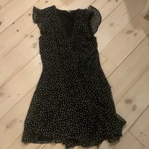 klänning från nelly.com  - en svart klänning med vita små hjärtan på och säljer pågrund av att den inte kommer till användning 