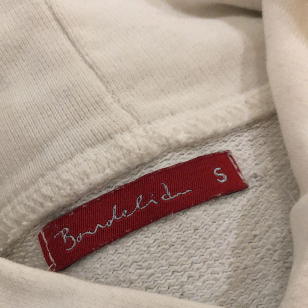 Vit vintage hoodie från bondelid. Notera ett litet hål ovanför fickan som även finns bild på. Hoodie är ganska lite och kort eftersom att den är i strl S. Köparen står för frakt🥰🥰. Tröjor & Koftor.