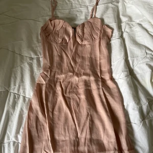 Rosa skimrig klänning strl S - Helt oanvänd rosa klänning i storlek 36/S. Passar även XS. Faller snyggt på kroppen och sitter tight runt midjan. Silkes material som är lite ”skimrigt” Justerbara axelband, dragkedja finns och elastiskt band i ryggen💖 färg visas rättvist på bild 3. Frakt 52kr