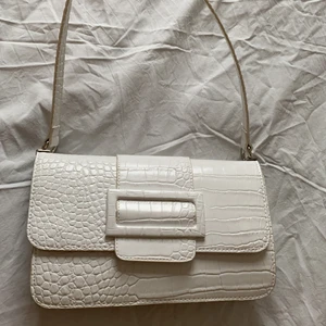 Nelly väska  - Vit Nelly väska med innerfack  . Använd sparsamt och därför i  väldigt bra skick. Köpt för 350.