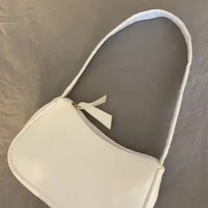 En vit väska i skinn med ett kort axelband och väldigt rymlig , skit snygg men kommer sällan till användning, köparen står för frakten 💖