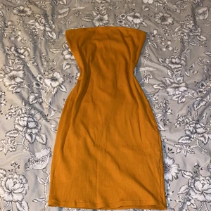 Gul tub klänning  - Gul/orange tub klänning. Lappen kvar, insåg att jag inte passade så bra i gult och kunde inte lämna tillbaka. 