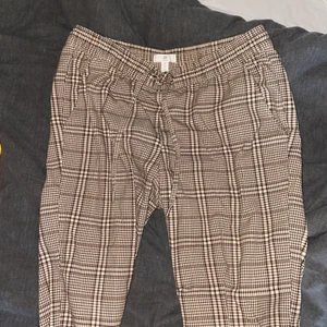 Rutiga byxor - Ett par rutiga byxor, väldigt mjuka i materialet och har rymliga fickor där fram. Storlek 42 men sitter bra på en 38/40 då det går att knyta vid midjan. 