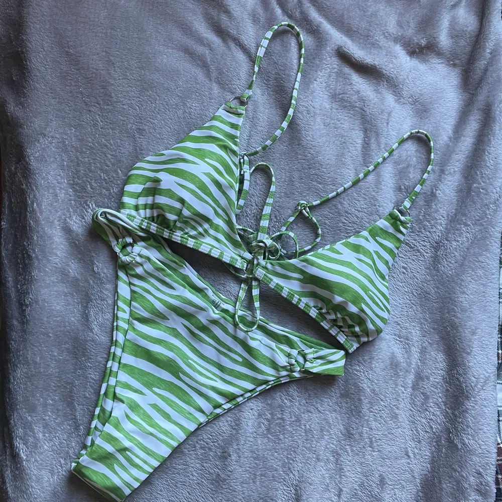 Superfin grön zebra bikini, aldrig använd med trosskyddet kvar. Justerbara band och knytning där bak. . Övrigt.