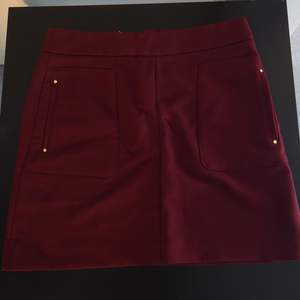 Size 38. Deep rich red (wine red) with golden zipper and pockets on the size. Fits really great. Brand new, never got to wear it.