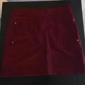 Size 38. Deep rich red (wine red) with golden zipper and pockets on the size. Fits really great. Brand new, never got to wear it.