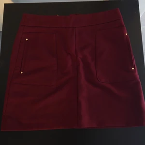 Dark deep red short pencil skirt - Size 38. Deep rich red (wine red) with golden zipper and pockets on the size. Fits really great. Brand new, never got to wear it.