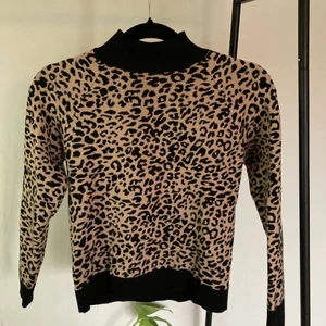 Stickad tröja med leopardmönster - Fin stickad tröja med leopardmönster och polokrage. Den är i fint skick, bara använd ett fåtal gånger. Köpt från Asos. Köparen står för frakten🤎🤎🤎