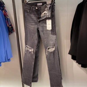 Gråa jeans - Säljer mina helt oanvända Zara jeans! Byxorna har hål på knäna och slit nedtill. Köparen står för frakten💕💕