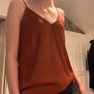 Rostorange topp - Bra skick och lite använd. Säljer då den inte kommer till användning. Blusaktig topp. Köparen står för frakten. Hör gärna av dig vid frågor🥰