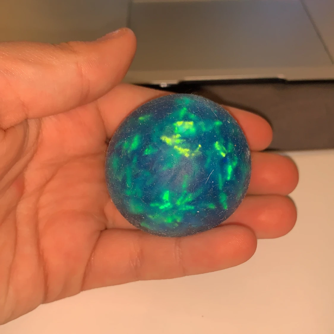 En blå liten vatten stress boll med glitter band i sig