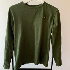 Mossgrön långärmad t-shirt från Lyle & Scott. Junior storlek, 14/15 år. Väldigt fint skick. Betala via swish och frakt tillkommer.