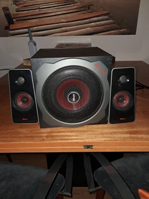 Trust trådlöst högtalarsystem - Snyggt trådlöst högtalarsystem från Trust med två svarta satellithögtalare och en kraftfull subwoofer. Designen har röda detaljer och metallgaller framtill. Perfekt för att boosta ljudet till datorn eller mobilen. Materialet är mestadels plast och metall.