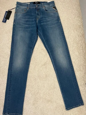 Replay Hyperflex jeans blå 30/32 - Snygga Replay Hyperflex jeans i klassisk blå tvätt. Perfekt för dig som vill ha stilrena jeans. Jeanes är helt oanvända med prislapp kvar. Pris går att diskutera vid snabb affär!