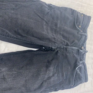 Svarta jeansbyxor comfort fit 30/30 - Säljer ett par svarta jeansbyxor i comfort fit med klassisk femficksdesign och snygga kontrastsömmar. Byxorna har normal passform och är perfekta för dig som vill ha både stil och bekvämlighet. Storlek 30/30.