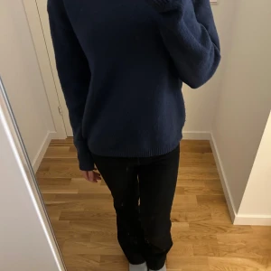 Mörkblå stickad tröja från Kappahl - Mysig mörkblå stickad tröja från Kappahl i storlek 158/164. Tröjan har en klassisk rund halsringning och långa ärmar. Perfekt för kyliga dagar och enkel att matcha med jeans eller andra byxor.