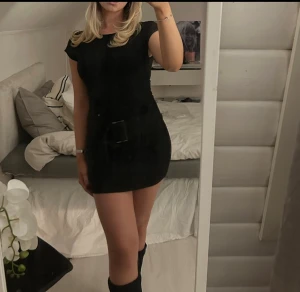 Svart kortklänning  - Säljer en svart kortklänning med en snygg bältdetalj i midjan. Kommer tyvärr inte till användning och därav säljs den. 