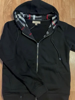 Svart burberry zip up - Snygg zip-up hoodie från Burberry. Stilren design med dragkedja och klassiska detaljer. Oanvänd och i fint skick. 