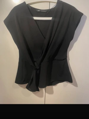 Svart omlottopp från Zara - Säljer en svart omlottopp från Zara. Storlek XS, bilden är lånad🖤
