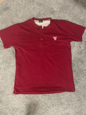 Röd kortärmad t-shirt från GANT - Säljer en röd t-shirt från GANT i storlek S men det står M. Riktigt snyggt och klassiskt stil.
