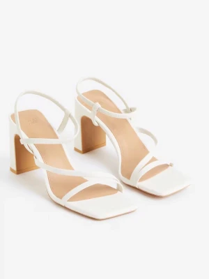 Vita sandaler med blockklack - Stilrena vita sandaler med fyrkantig tå och bred blockklack. Tunna remmar över foten och runt ankeln ger en modern look. Perfekta till sommarens outfits och lätta att matcha. Tillverkade i syntetmaterial.