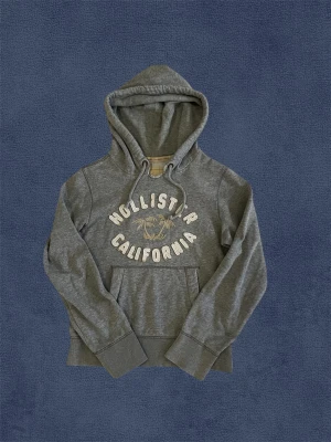 Hollister Hoodie - Säljer nu denna sjukt feta hoodien från Hollister. Bra skick, inga större deffekter. Modellen är: 176, 59kg. Storlek S, mått finns på bilderna. 