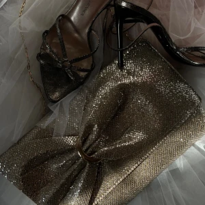 Rosett väska - Gossip Bag 🍸🪩 399kr  Stolek: S Typ: Kuvertväska Färg: Silver