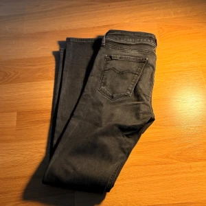 Replay svarta jeans - Snygga svarta jeans från Replay med klassisk femficksdesign och Replay-logga på myntfickan. Modellen är skinny med smal passform och raka ben. Jeansen har en mörk tvätt och är tillverkade i stretchigt jeansmaterial för extra komfort.