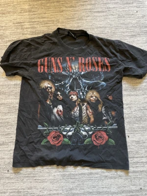 Guns N' Roses svart T-shirt - Svart t-shirt med stort Guns N' Roses-tryck både fram och bak. Använd men fortfarande bra skick