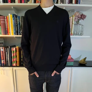 Mörkblå v-ringad tröja Tiger of Sweden - Asfet mörkblå tiger of sweden stickad tröja! Inga tecken på användning, modellen är 177 och väger 60kg! Tröjan är gjord av italienskt garn och materialet är mycket skönt mot kroppen!