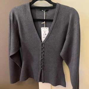 Grå kofta med v-ringning och knappar - Supersnygg kofta/tröja från Gina Tricot i storlek XS. Perfekt att styla med jeans eller kjol. Har klippt av prislappen nu men har aldrig använt endast testat!❤️