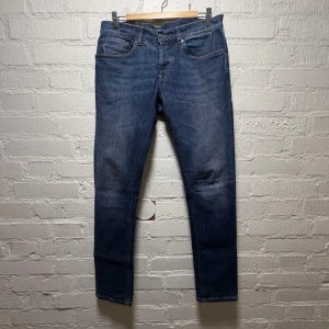 Dondup George skinny fit jeans blå - Snygga blå skinny fit jeans från Dondup med klassisk femficksdesign och kontrastsömmar. Jeansen har en smal passform och är tillverkade i jeansmaterial med en mörkblå tvätt. 