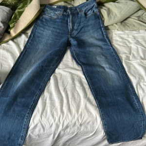 Levi's Stay Loose blå jeans W30 L34 - Säljer ett par blå Levi's Stay Loose jeans med riktigt avslappnad passform och raka, vida ben. Klassisk femficksmodell i jeansmaterial med snygg tvätt och detaljerade sömmar. Perfekta för dig som gillar en loose och trendig stil.