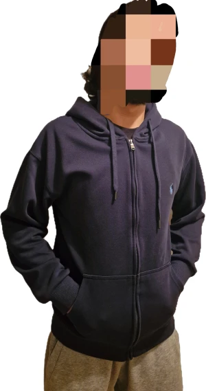 Mörkblå kofta Polo Ralph Lauren (M) - Snygg mörkblå hoodie från Polo Ralph Lauren med dragkedja och huva med snörning. Koftan är jättebra kvalite och i nytt skick. Tröjan har långa ärmar, ribbade muddar och en broderad logga i ljusblått på bröstet. Tillverkad i mjuk bomull och har praktiska fickor framtill.