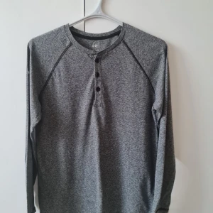 Grå långärmad tröja från H&M strl 170 (barn) - Säljer en grå långärmad tröja från H&M i mjuk bomull. Tröjan har rund halsringning och tre knappar framtill. Storlek EUR 170. Kan hämtas i Vallentuna.