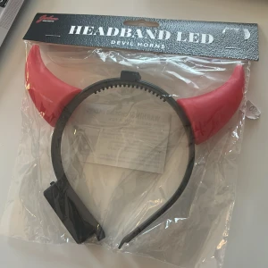 djävulshorn - LED - Säljer ett svart diadem med röda djävulshorn som lyser med LED-ljus. Perfekt accessoar för temafester eller halloween. Oanvänd!