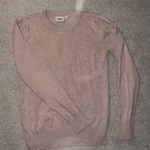 Ljusrosa stickad tröja Saint Tropez - Supersöt ljusrosa stickad tröja från Saint Tropez i storlek XS. Tröjan har rund halsringning, diskreta puffdetaljer vid axlarna och långa ärmar. 