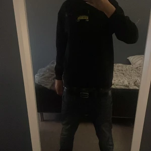 Svart Santa Cruz hoodie - Svart hoodie från Santa Cruz i storlek M med färgglatt motiv och logga på ryggen samt mindre tryck på bröstet. Tröjan har huva med snörning.