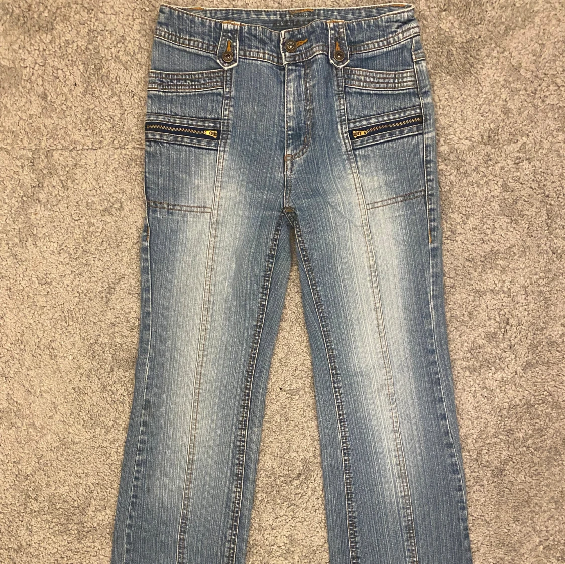 Blå jeans med dragkedjedetaljer