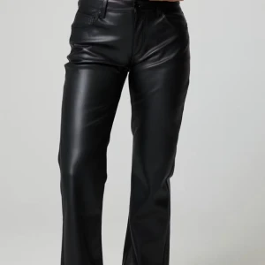 Svarta skinnbyxor med raka ben - Snygga svarta byxor i skinnimitation med raka ben och klassisk femficksdesign. Byxorna har normal midja och stängs med dragkedja och knapp. Perfekta för dig som vill ha en edgy och trendig look.