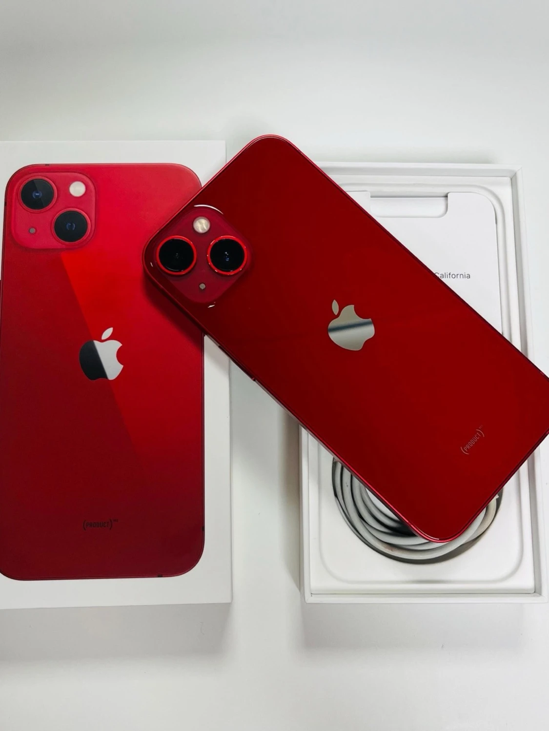 Röd iPhone 13 med box och laddkabel