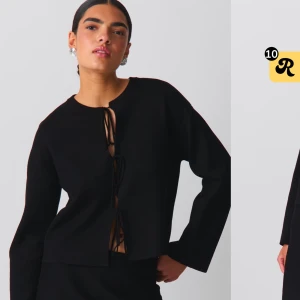 Svart tröja med knytning - Snygg svart tröja med knytning framtill. Den har en stilren design med långa ärmar och en rak passform. Perfekt för en elegant look, endast använd 1 gång 