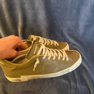 Olivgrön sneakers med snörning kvitto finns! - Snygga olivgröna sneakers med vit sula och snörning. Perfekta för en avslappnad stil. Skorna har en klassisk design med en diskret logga på hälen. Bara skorna följer med ✅ Priset är väl diskuterbart✅Kvitto finns!