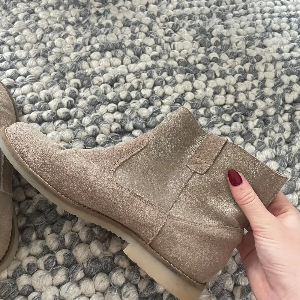 Säljer ett par snygga beige boots i mocka. Skorna är i mycket bra skick. Använda fåtal gånger. Storlek normal 37. Skor.