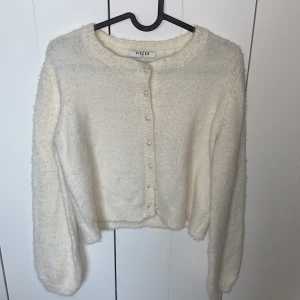 Vit Cardigan  - Vit Cardigan från Pieces i str XS. Aldrig använt då den är lite för liten för mig. Jag är en M i dam (bild 3 ser du den på mig).  Den är lite croppad.