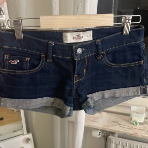 Mörkblå jeansshorts från Hollister - Snygga mörkblå jeansshorts från Hollister som är jätte lågmidjade💕. Skriv för fler bilder på gärna☺️☺️. Säljer dessa då dem är för tighta för mig. Shortsen är i storlek 23💗💗. Priset går att diskuteras vid snabbt köp☺️.