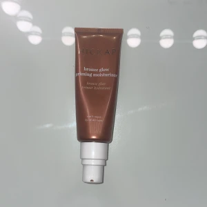 Bronze Glow Priming Moisturizer - En bronzig priming moisturizer som ger huden en strålande glöd. Perfekt för att skapa en jämn bas med en lätt solkysst effekt. Kommer i en praktisk tub med pump för enkel applicering.