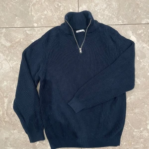 Mörkblå stickad tröja med dragkedja - Snygg mörkblå stickad tröja från Zara med halv dragkedja och hög krage. 