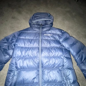 Blå dunjacka från PeakPerformance - Säljer en snygg blå dunjacka från PeakPerformance, Jackan har en praktisk dragkedja och en mysig huva för extra värme. Perfekt för kyliga dagar och håller dig varm och bekväm, storlek S och skick 9/10 eftersom att den bara är använd en halv vinter. Medans nypriset är cirka 2499! Så är mitt pris 999kr!🔥